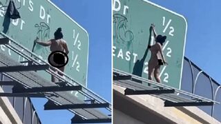 Cops Stand Around to Watch Naked Woman Spray Paint on a Highway Sign.