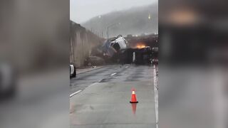 Truck Tumbles Over Side Of Freeway, Lands On Wreckage From Earlier Crash.