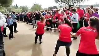 Woman pulls the Wrong Way in a tug-a-war match (No Joke)