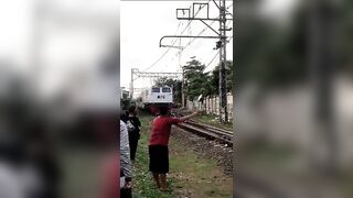 Kid Lays Down in Front of Train to the Surprise of others watching