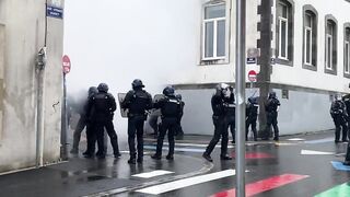 Bumbling Riot Police Tripped up by Makeshift Tripwire just Laying There