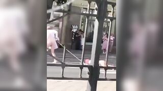 Two Russian men half-naked walking the streets in Russia. One of them is being dragged