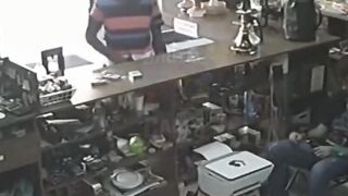 Robber is literally Blown out of the Shop with a Handgun