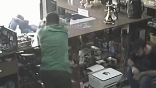 Robber is literally Blown out of the Shop with a Handgun