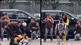 Cardi B giving a lap dance to a robot until it falls on top of her