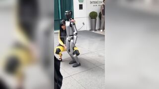 Cardi B giving a lap dance to a robot until it falls on top of her