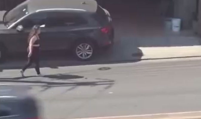 Woman walking away from police is Thrown a Few Meters (Brutal Wait for it)