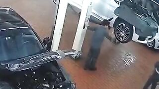 Car Falls on Mechanic as Entire Shop tries to Save Him