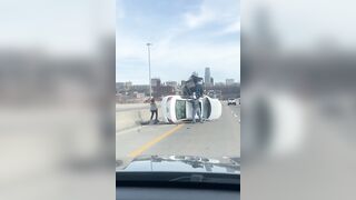 Car flipped over on the highway, leaving a mother and child trapped inside