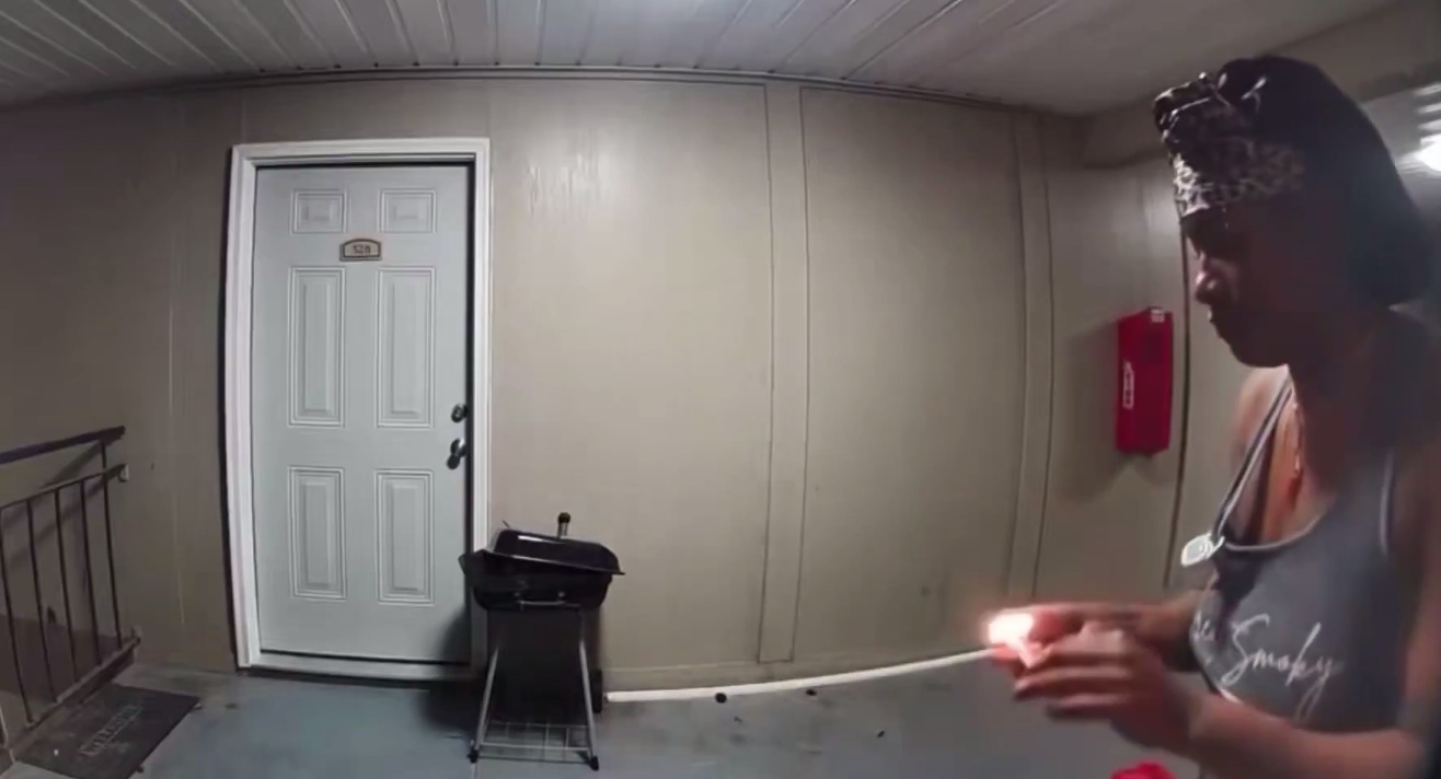 Shower cap woman attempts to set fire to a residential dwelling.
