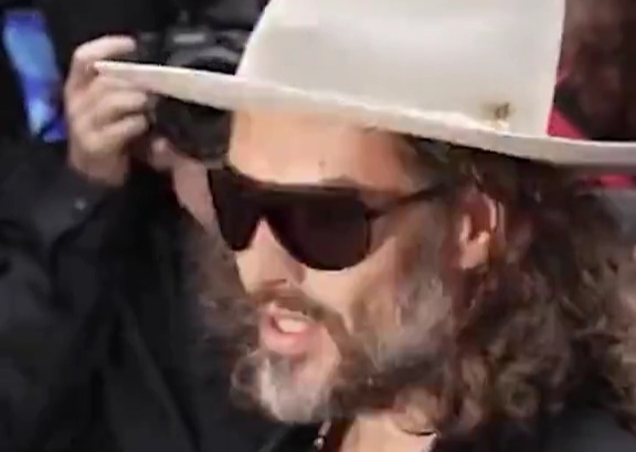 Russell Brand tries to read the Bible in court as he pleads not guilty to raping