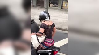 Blonde on Back of Motorcycle is Having a Blonde Moment