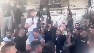 10 Year Old Girl Ak-47 in one hand, Pistol in the other. Hamas Celebrates Occupation of Israel