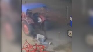 Unbelievable Video shows Man get Run Over by his Own Tractor..then
