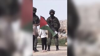 Moment from the War: Little Girl holds Palestine Flag Up and Blocks Israeli Soldiers