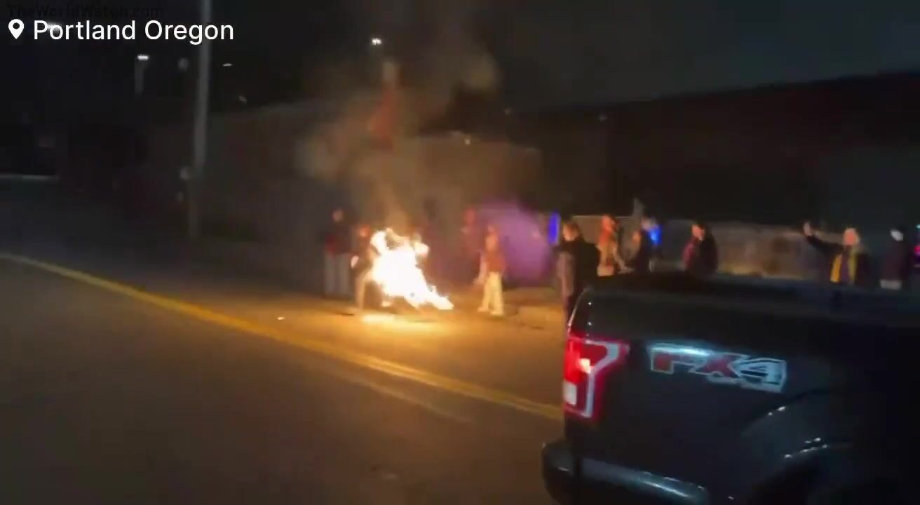 Anti-ICE protester accidentally lights himself on fire while attempting to burn an American flag