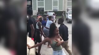 Fight breaking out at a Houston apartment complex when a woman, swinging a baseball bat, starts hitting a man