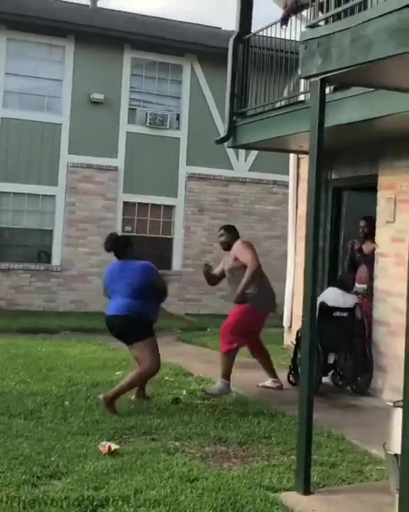 Fight breaking out at a Houston apartment complex when a woman, swinging a baseball bat, starts hitting a man