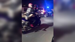 Female on her BACK on a Motorcycle Taunting the Cops...this is Wild