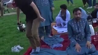 American Man interrupts Islamic evening prayer in the park.
