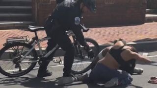 Two black women are fighting when out of nowhere a police officer on a bicycle comes and RAMS into them