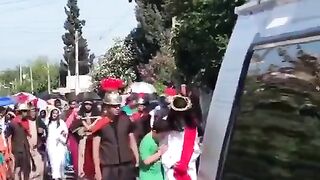 A boy with Downsyndrome comforts Jesus during a Good Friday procession in Mexico