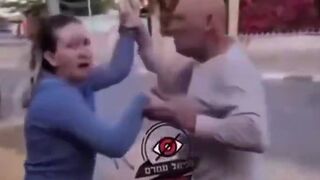 An Israeli man blocks a woman from entering a shelter because she has a dog.