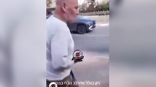 An Israeli man blocks a woman from entering a shelter because she has a dog.