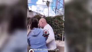 An Israeli man blocks a woman from entering a shelter because she has a dog.