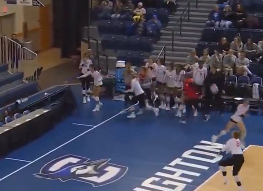 College Female Volleyball Player Dives into a Table to make the Save