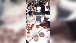 Server takes a Risky Shot Carrying Al this Beer to a Table