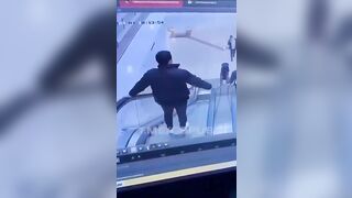 Random Jerk Kicks a man Down an Escalator