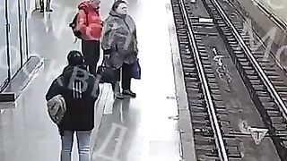 Watch Top of Screen. 60 Year Old man pushes 15 Year Old Boy under the Train