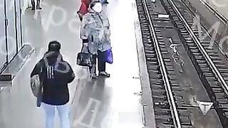 Watch Top of Screen. 60 Year Old man pushes 15 Year Old Boy under the Train