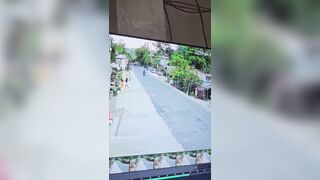 Woman trying to Cross the Road lines up perfectly with Biker