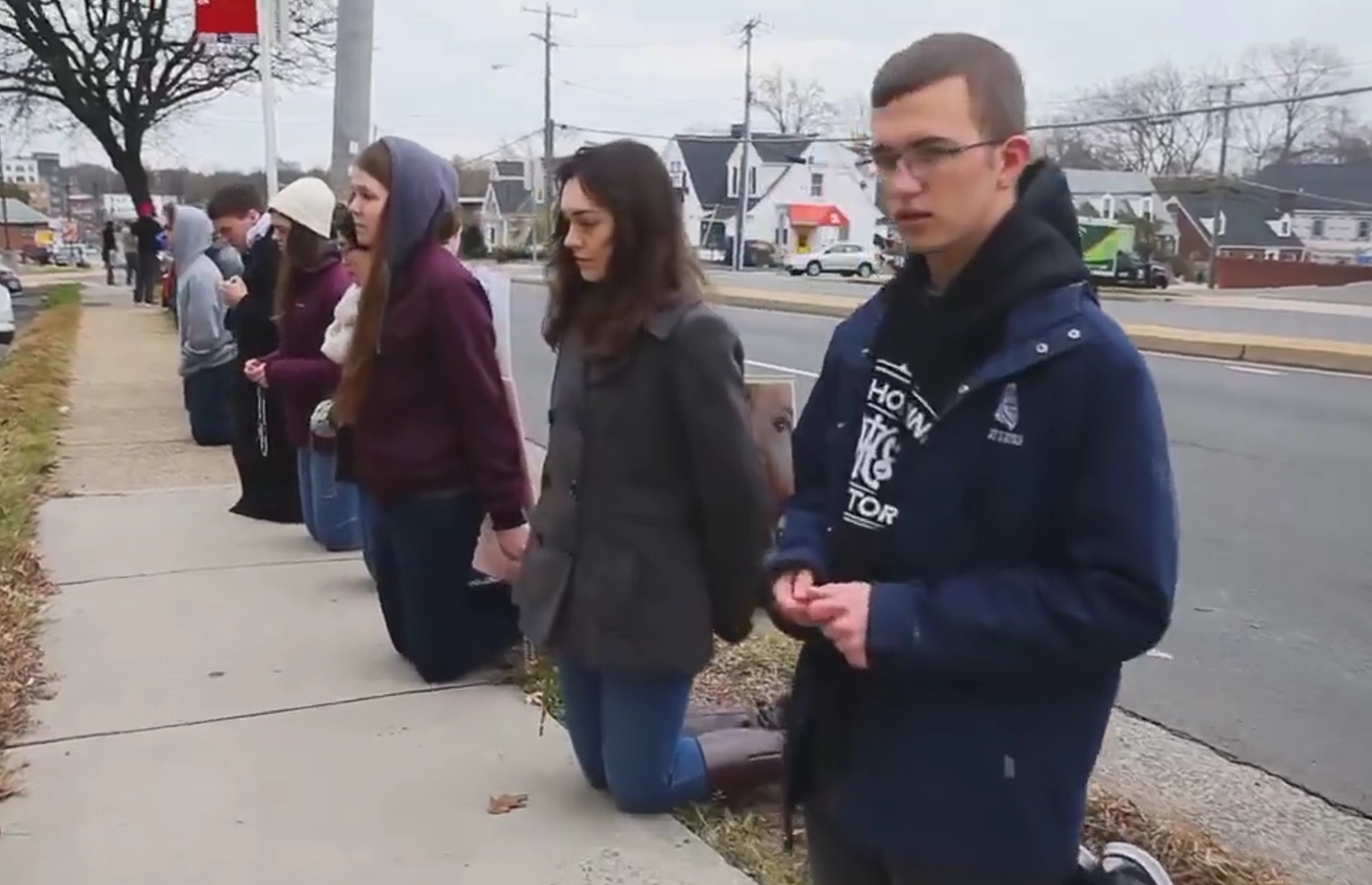 Christendom college students pray the Rosary on their knees outside an abortion clinic in Virginia