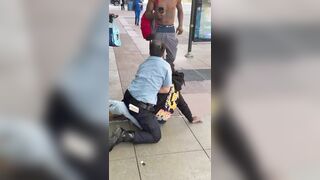 A man is seen trying to take another man’s phone, not realizing the person he approached was a police officer