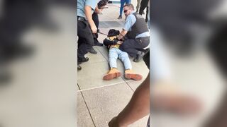 A man is seen trying to take another man’s phone, not realizing the person he approached was a police officer
