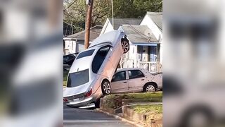 Is this Guy really Trying to Pull his Car off of Street Pole ?