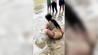 Indian woman washing clothes in CANADIAN river