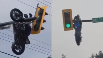 Motorcycle seen HANGING from traffic light after violent crash