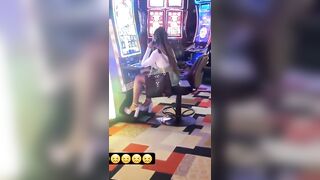 Woman Pissing on the Floor at Casino on the Phone doesn't Care