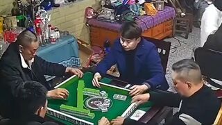 Serious Domino Players get Interrupted by Rude Building