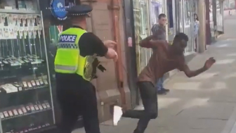 UK Officer Under Investigation After Video Showed Him Pushing A Migrant