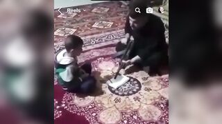 Islamic Dad helps His Son do Hommework at Gunpoint