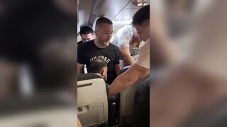 Passengers restrain a man onboard a Frontier Airlines flight to Chicago's O'Hare
