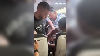 Passengers restrain a man onboard a Frontier Airlines flight to Chicago's O'Hare