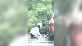Man is going viral after being filmed watching his girlfriend change a car tire in the rain and not help
