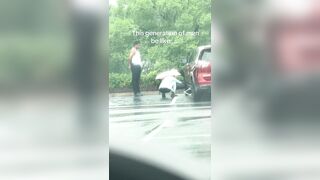 Man is going viral after being filmed watching his girlfriend change a car tire in the rain and not help