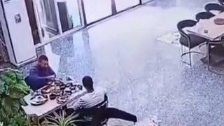 2 Men Eating Breakfast get an Unwanted Intruder on the Table